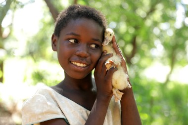 Omega (9) with her duck in Mchiliko, Nsanje. 