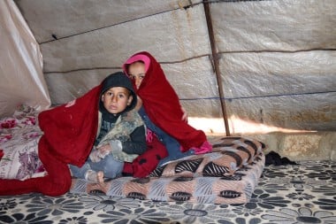 Seham's* daughter Jamila* (10) and son Fadi* (7) trying to keep warm
