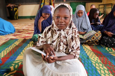 Amina Garba holding a book