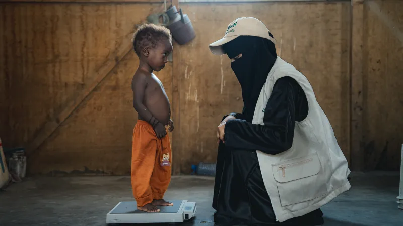 Child being weighed at Yemen malnutrition centre