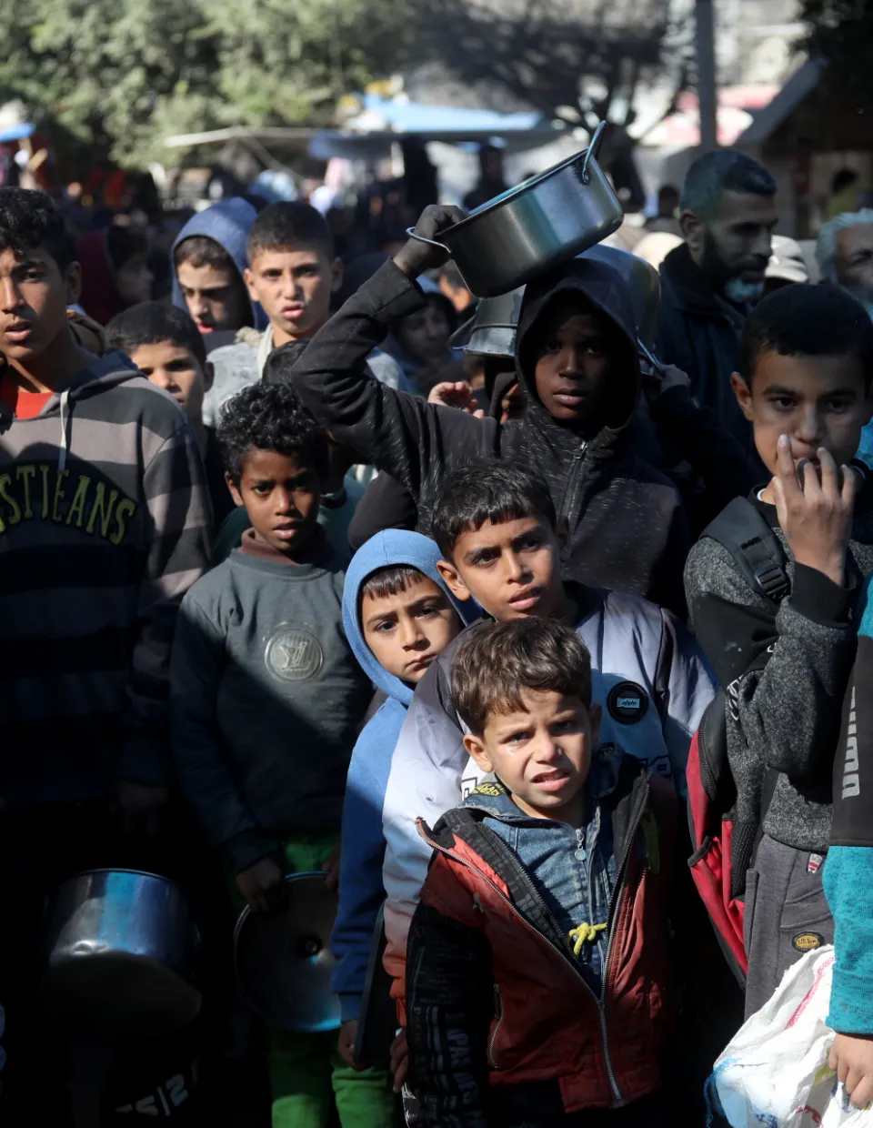 Children queue for aid in Gaza.