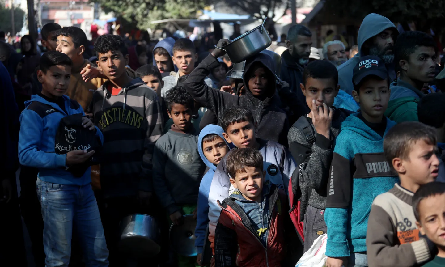 Children queue for aid in Gaza.