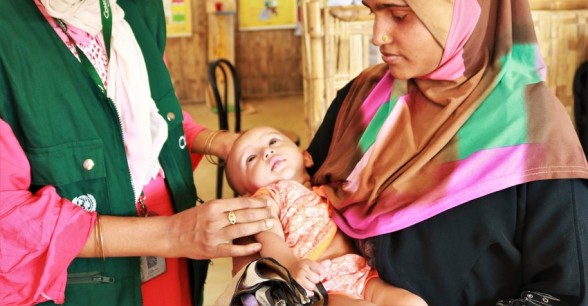 The nutrition counsellor of Concern’s Jamtoli OTP centre Saleha Akter Jhuma is checking the health condition of Uzair (not real name). He came OTP for follow up check-up. When Uzair came to Jamtoli OTP centre, he was severely malnourished and had very low appetite. After taking the nutritious diet for three weeks, Uzair is a healthy baby now. Nutrition counsellor Jhauma and Uzair’s mother Salma (not real name) both looks very happy to see his improved health condition. Photo: Tariq Adnan/ Concern Worldwide.