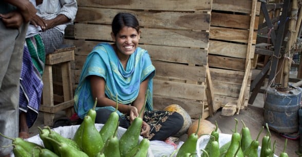 Moni selling vegetables at Karwan Bazar market in Bangladesh. The business was started after receiving a grant from Concern. Photo: Abbie Trayler-Smith/Panos Pictures for Concern Worldwide