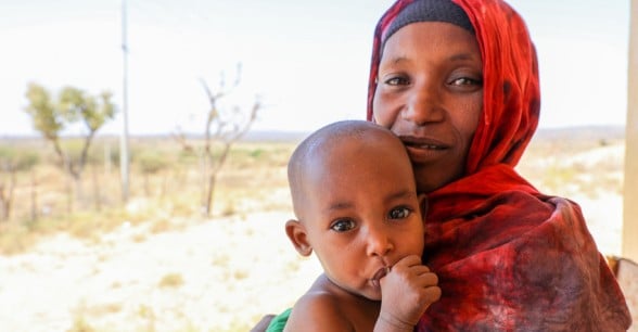 Khayro holds her baby daughter, Halimo, who is healthy and happy again after receiving emergency therapeutic food from Concern. Photo: Jennifer Nolan / Concern Worldwide.
