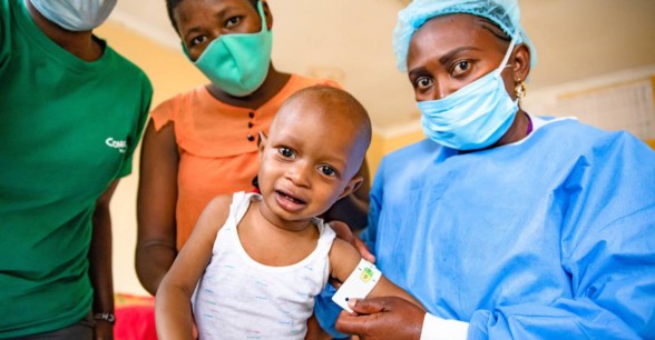 Jane Wanjiru has brought her baby son Mark Moses to Mukuru Health Centre. Facility staff Damaris Too and Nutritionist Angela Mtiini assess Mark Moses nutritional level, they take his weight, MUAC and other measurements. Photo: Ed Ram / Concern Worldwide