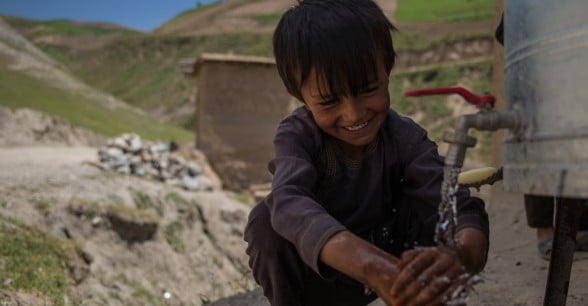 Asad* (6) washes her hands at the newly installed water station.Photo: Stefanie Glinski / Concern Worldwide