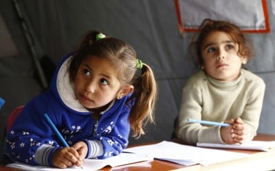 Farah* and Nadia* attends a non-formal education programme in an informal settlement that focuses on early childhood education in Akkar, north Lebanon. Photo: Chantale Fahmi/Concern Worldwide.