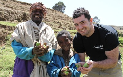 Smiling Apple Farmers, Father and son, Ebrie and Mohammed Ali Demsie with Rob Kearney showing their crops in Dessie Zuria, Ethiopia. Photo: Jennifer Nolan / Concern Worldwide
