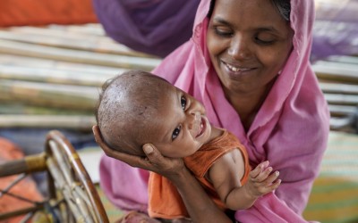Noor* (21) holds one of her twin girls Nur* at their tent, Jamtoli, Ukhiya. Photo: Abir Abdullah / Concern Worldwide.