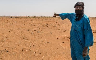 Mahamadou Islam Garmaz, Chief of Garmazaye village, points to the arid landscape