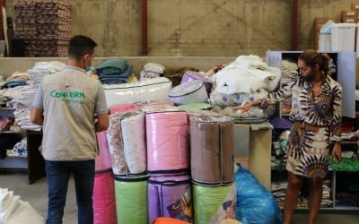 Concern's Warehouse Manager, Mohammed along with Sawsan and Miriam from a local volunteer group, do a stock take of blankets. Photo: Jade van Huisseling
