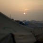 Sun rising over tents in north west Syria