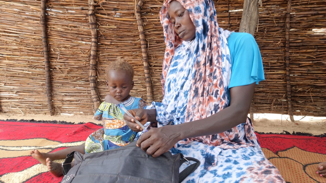Khamissa Ibrahim is 32 years old. She has six children: Fatouma (9), Ahmad (7), Zakia (5), Aisha (4), Umaima (3) and Rafaida (1 and a half) – pictured – and is six months pregnant. Khamissa is a Concern-trained Community Health Volunteer. She also sells onions, salt, garlic, oil, okra and chili. Before Concern, she worked in the fields to support her family during the lean period. Khamissa is independent and runs her own business. She stores millet, peanut and sesame and from these stores, she loans stock t