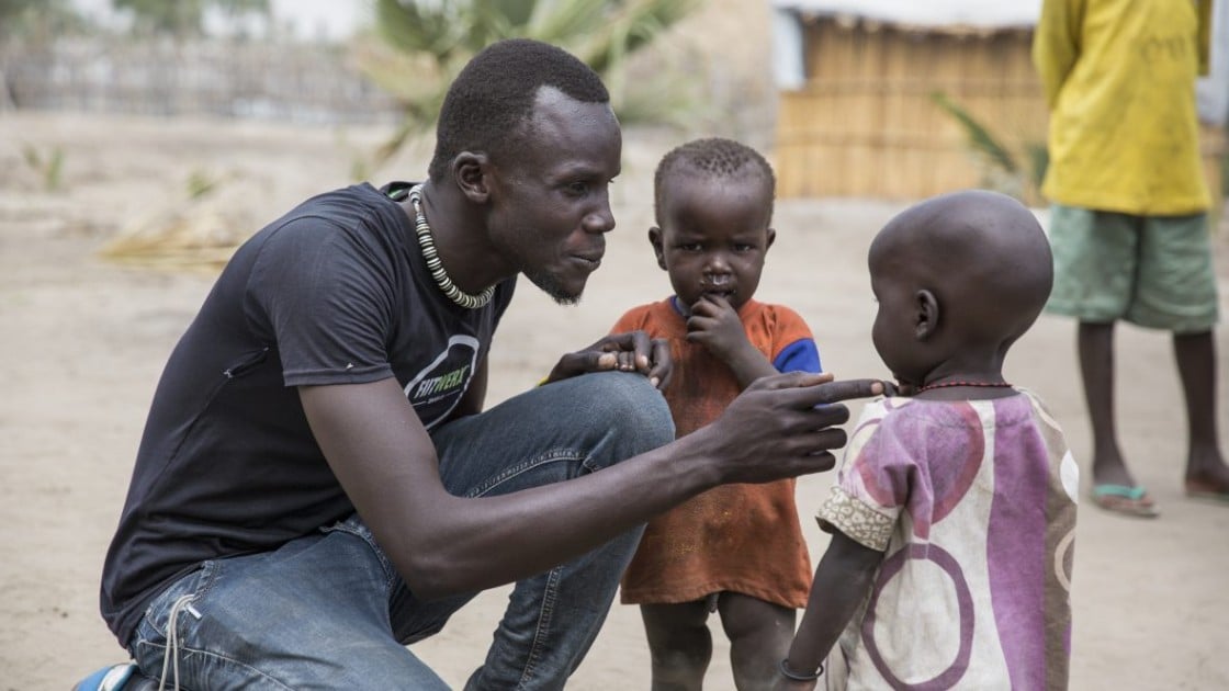 John Deng of South Sudanese NGO, Nile Hope, with some children on the island of Touchriak in Unity State. People have been hiding on the islands from fighting.