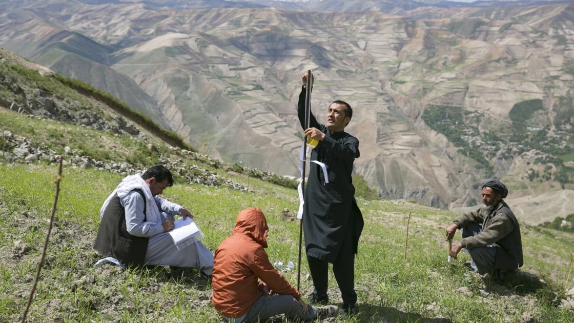 Setting measuring stakes on a hillside as part of a Concern watershed management project in Afghanistan. Photo: Kieran McConville / Concern Worldwide