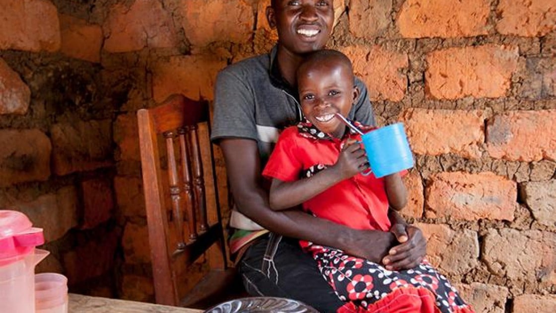 Megisela Muhoza (6) daughter of Gerard Ndabahekeye (28) at their new kitchen table and chairs. Photo: Abbie-Trayler Smith / Concern Worldwide.