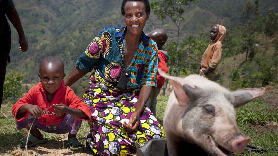 Violette Bukeyeneza (45) and her son Lievain Irankunda 3 (M) with the pig she has bought from the profits of her business at her home in Bukinanyana, Cibitoke, Burundi. Photo: Abbie Trayler-Smith / Concern Worldwide.