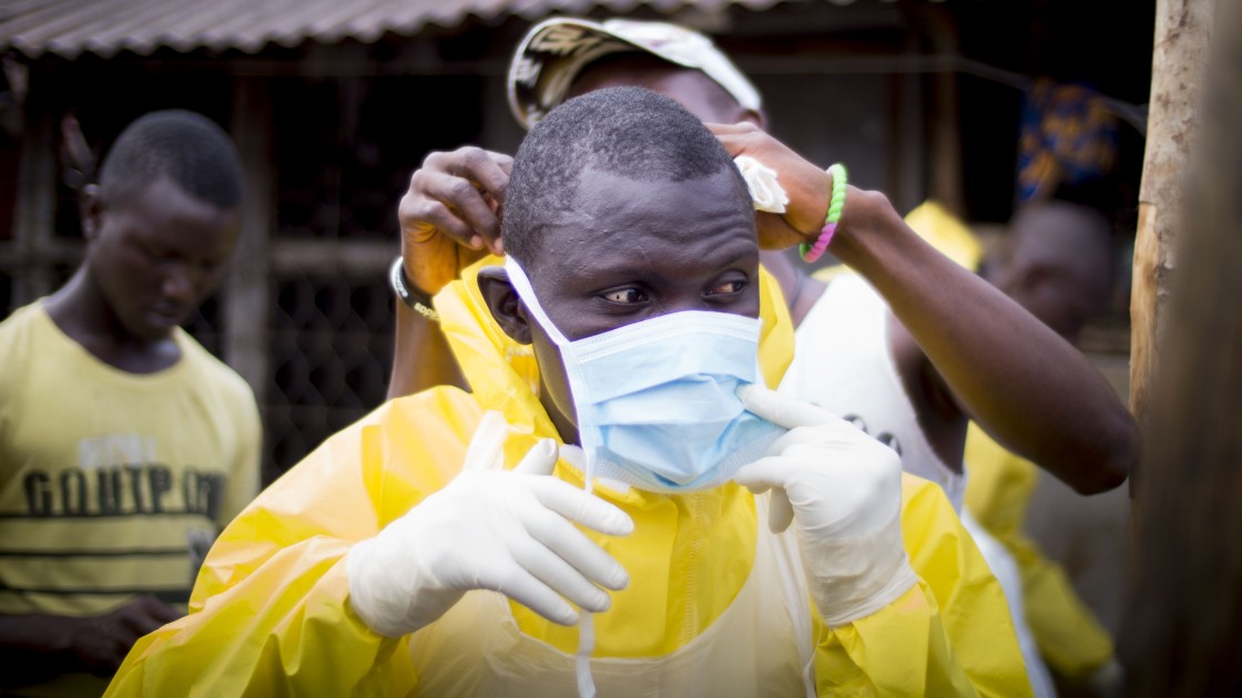 Members of Concern Worldwide's "Burial Team 7" attend the home of a 44 year old woman, who it's suspected died of ebola in the New England area of Freetown, on Wednesday night. 73 people were buried in on Wednesday October 29th in Western Area, which includes Freetown and its suburbs. All home deaths in the city are now attended by medical burial teams.