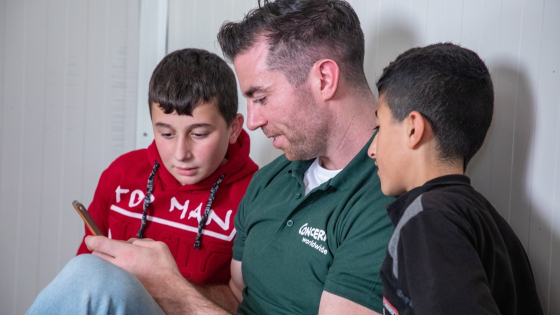 Dublin footballer Michael Darragh Macauley with two Syrian boys in Iraq where he visisted refugees being helped by Concern Worldwide in November 2019. Photo by Gavin Douglas of Concern Worldwide