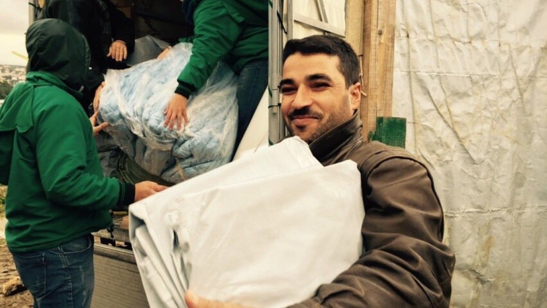 Ahmad el Ezzou receiving Non Food Items at an informal settlement in Lebanon. Photograph taken by: Amanda Ruckel/Concern Worldwide.