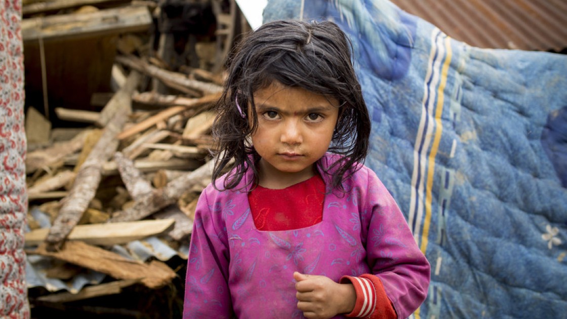 Shiwani Sapkota, in front of the remains of her home in the village of Kukhretar, Kabhrepalanckok district, Nepal. It was destroyed by the 25 April earthquake and she and her family are now homeless. Photo taken by Crystal Wells / Concern Worldwide.