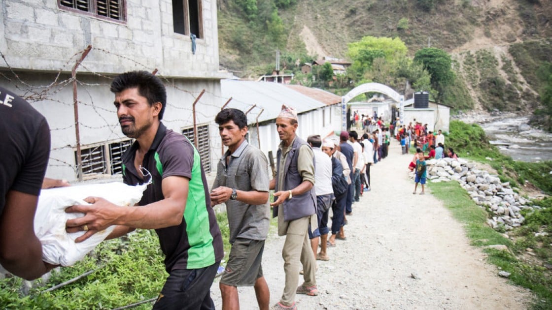 Supplies are unloaded at a Rural Reconstruction Nepal and Concern Worldwide team distribution in Talamarang, Sindhupalchok district, Nepal. Photo taken by Crystal Wells / Concern Worldwide.