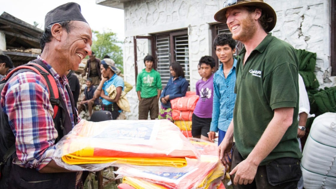 Concern Worldwide's Dom Hunt distributes tarps in Mane Banjang, a community high in the foothills in Sindhupalchok district, one of the hardest hit areas by the 7.8-magnitude earthquake that struck Nepal on 25 April. Photo taken by Crystal Wells / Concern Worldwide.