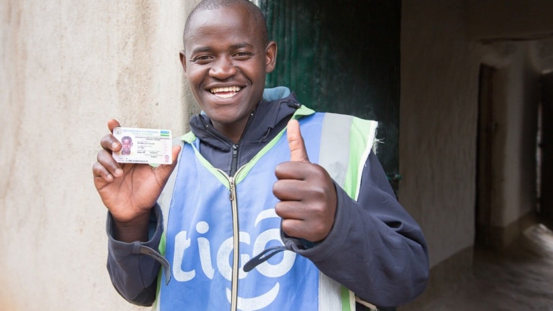 Jean Claude Minani shows off his prized motorcycle driver’s licence. He participated in Concern’s graduation programme in Rwanda and was able to start his own motorcycle taxi business. Photo: Robin Wyatt / Concern Worldwide, 2015.