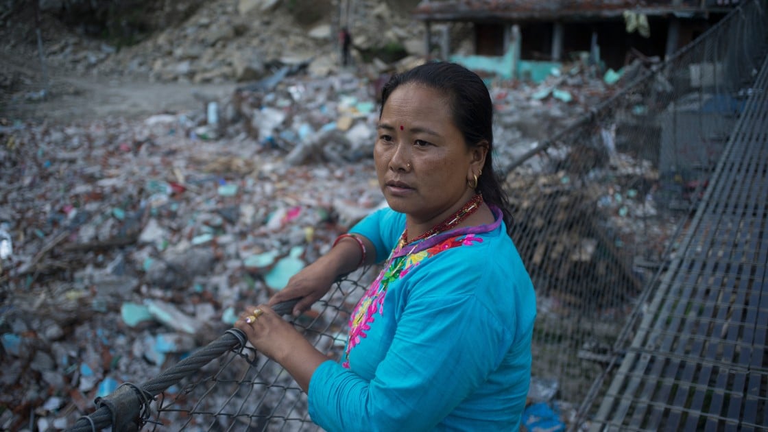 Sua Tamang overlooks the devastation caused by the earthquake in Dolakha District. Credit: Brian Sokol/Concern Worldwide.