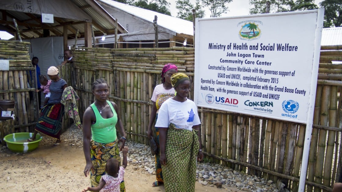 Women leaving the Community Care Centre in John Logan Town, Grand Bassa County, Liberia The centre, built by Concern Worldwide, was designed to treat Ebola patients but has been transformed into a general health centre. Photo taken by Kieran McConville / Concern Worldwide.