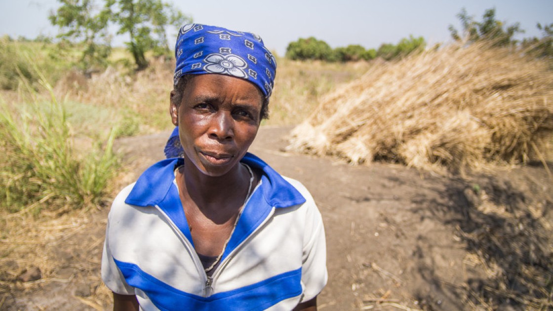 Lucia White in front of the site of the home she lived in for 20 years in Nsanje, Malawi. The house was washed away by the floods of January 2015. Lucia has been helped by Concern with emergency supplies and with seeds, fertilizer and goats. Photograph taken by: Concern Worldwide/Kieran McConville.