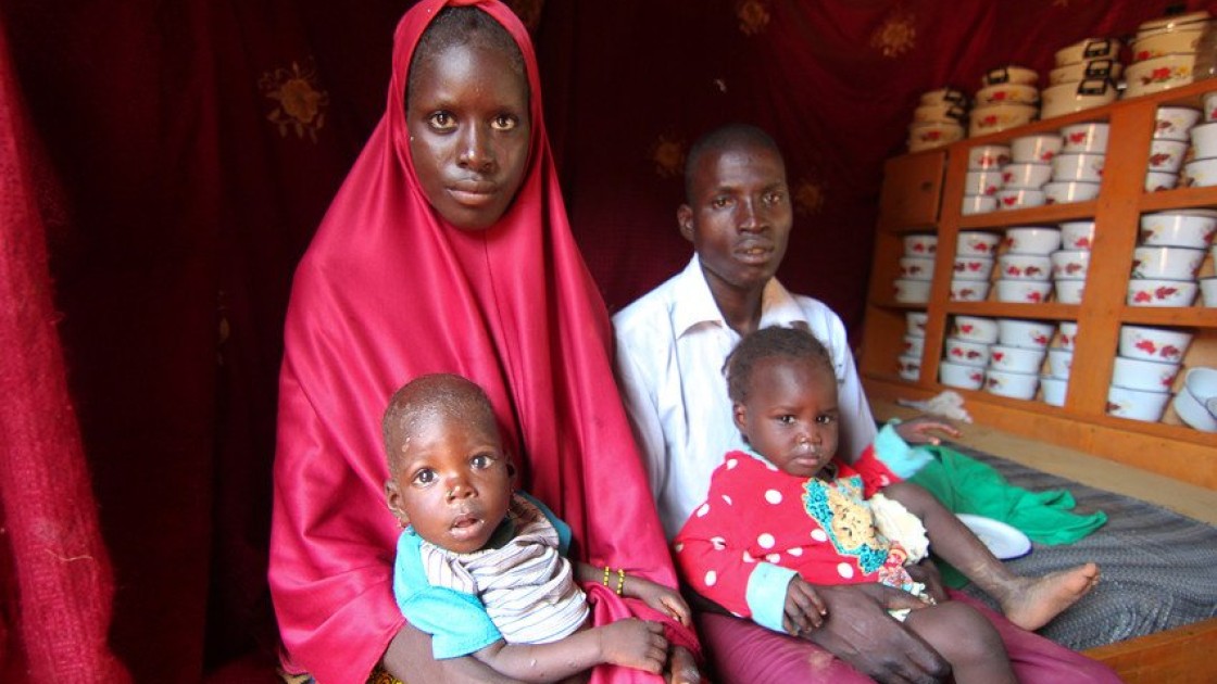 The Hassane family sit in their small house. Baby loubaba is severely malnourished and is attending a Concern Worldwide supported health centre in Commune de Bambaye, Tahoua, Niger for treatment. Photo: Jennifer Nolan / Concern Worldwide.