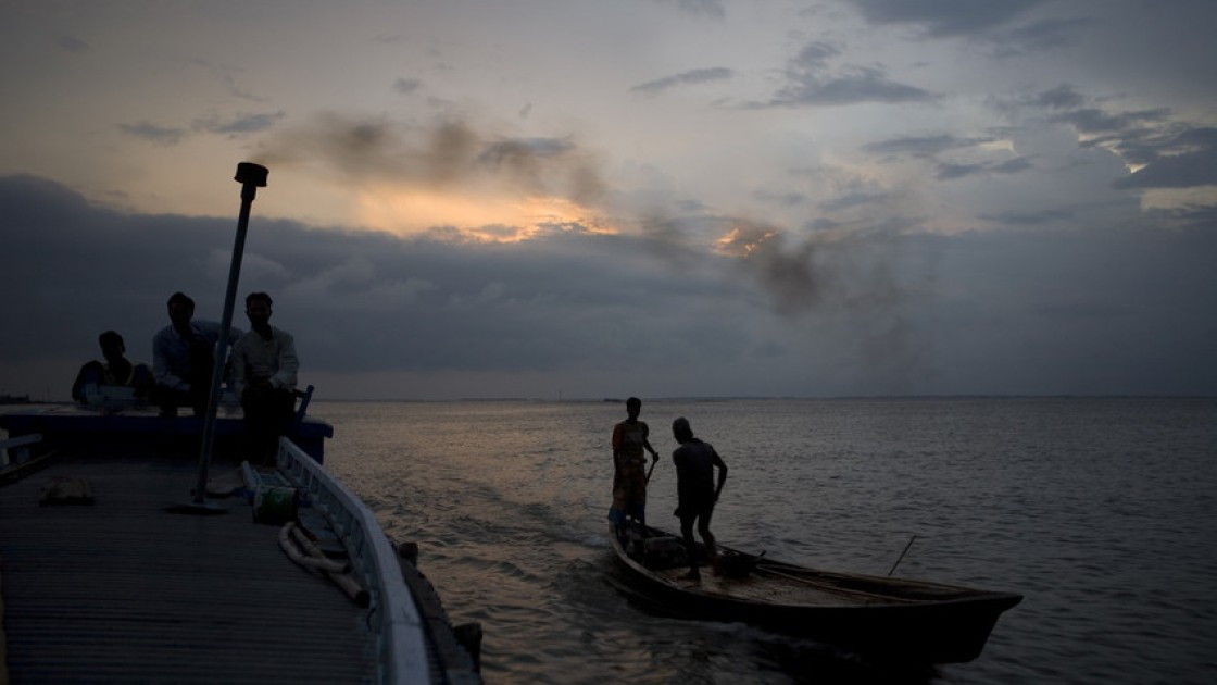 Two boats travel across the Haor flood plains of North East Bangladesh. For half the year this area is flooded and for the other half the waters recede allowing the islanders to grow crops on land. Photo taken by Gideon Mendel/Concern Worldwide.