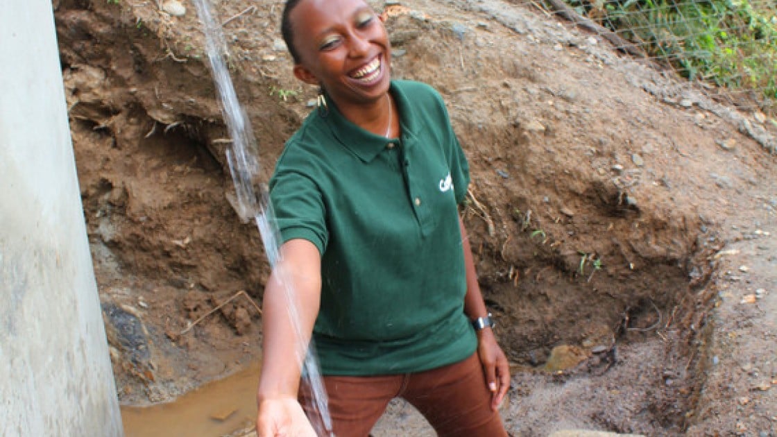 Gloria Kafuria, Concern Worldwide water and sanitation engineer, at a solar water system that she designed in Tanzania. Photo taken by Crystal Wells/Concern Worldwide.