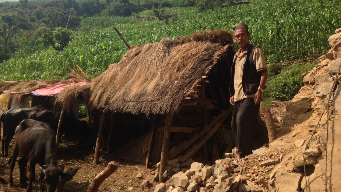 Dhan Bahadhur Waiva stands on the debris of his house in the remote, rural village of Rambheda, Sindhuli, Nepal. Photo taken by Daniel Gray/Concern Worldwide.