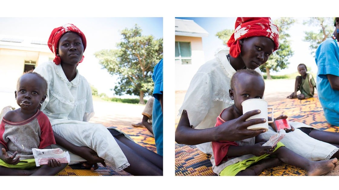 Yak sits with his mother, Achara, and eats ready-to-eat therapeutic foods at Mayom Health Care Unit in Aweil West County, Northern Bahr el Gazal, South Sudan. Photo: Crystal Wells/Concern Worldwide.