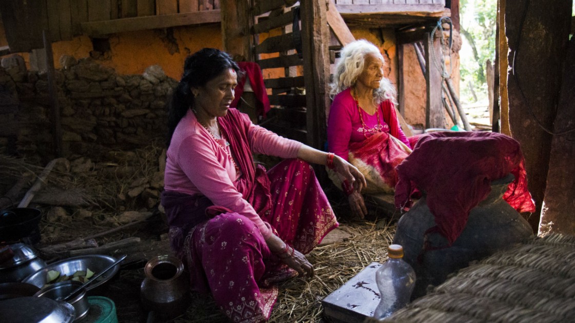 Two women cook in a house left standing after the Nepal earthquake. Photo taken by Crystal Wells/Concern Worldwide