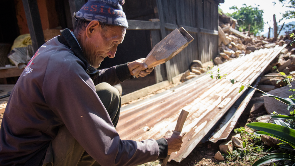 Nura Naryan Shristha works to recover building materials from his home in Bakrang, near the epicenter of the earthquake. Photo taken by Crystal Wells/Concern Worldwide.