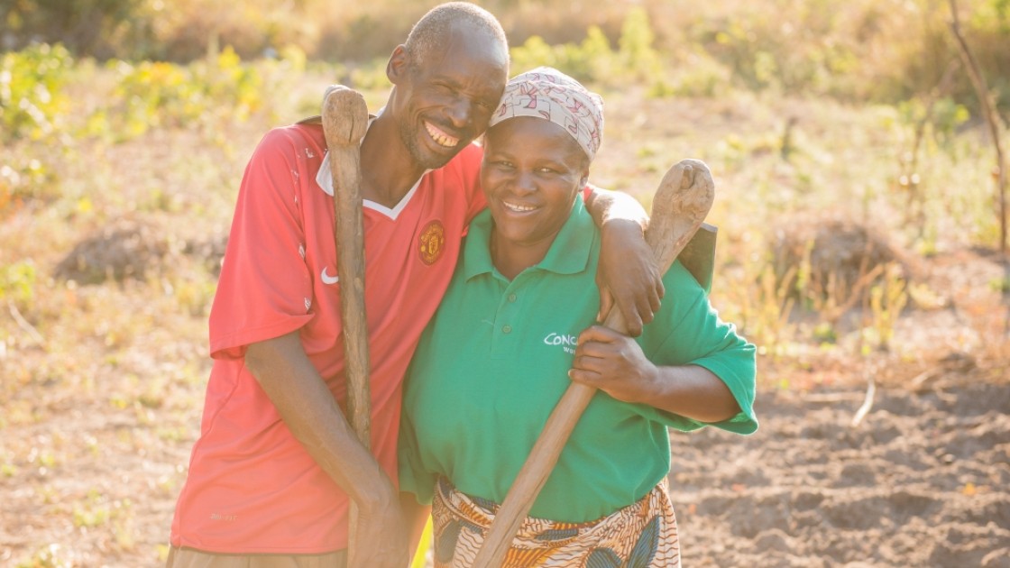 Chibala, 55, and Catherine, 43, work together in their field. Through attending gender training as part of Concern's RAIN programme he has now 'learned to help' his wife. Photo: Gareth Bentley.