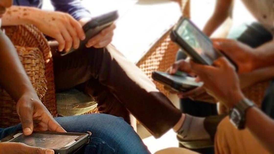 Enumerators practicing surveys on DDG devices during training in Nsanje, Malawi. Photo: Caroline Holo / Concern Worldwide.