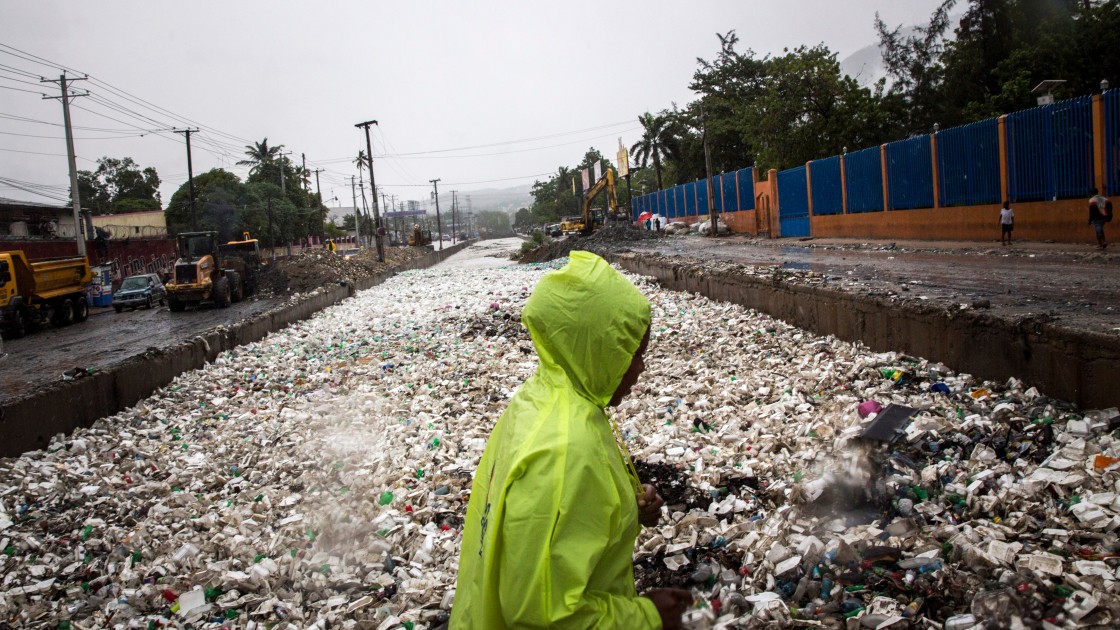 Woman pictured in littered street.