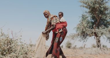 Nigerien woman and her daughter prepare a field for rainy season