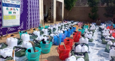 Rows of buckets, water cans and hygiene supplies