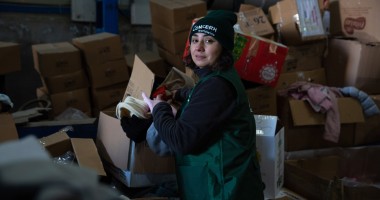 Woman with emergency relief items for earthquake affected communities