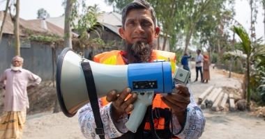 A member of the self-help committee with a megaphone for early-warning. Rangpur, Bangladesh. Photo: Gavin Douglas/Concern Worldwide
