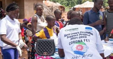 Concern vaccination team member records community members' information at a clinic