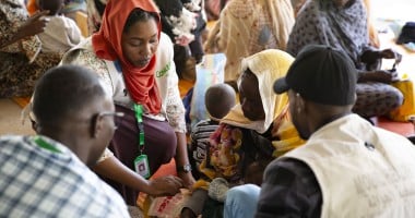 Concern Health and Nutrition Officer, Yamen Nassir, with Zarina* and baby Yaqub* at Ardamata Health Centre in West Darfur, Sudan. Yaqub* is severely acutely malnourished and has additional health complications. Photo: Kieran McConville/Concern Worldwide
