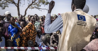 Gatkuoth Matai, Disaster Risk Reduction Officer with Concern South Sudan, speaks to people as they wait for a cash distribution in Chotyiel, Unity State. (Photo: Ed Ram/Concern Worldwide)