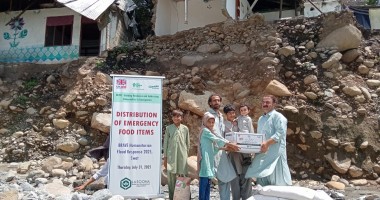 Dry food ration items are distributed to flood affected community members in Pakistan